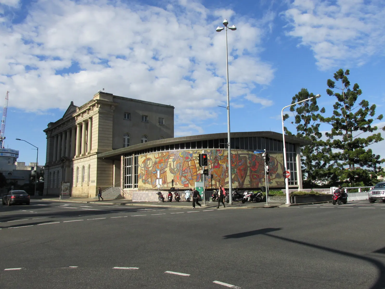 Das Tabcorp-Gebäude im Stadtzentrum von Brisbane mit einem modernen Anbau und einem bunten Wandgemälde.