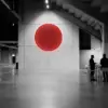 Monochrome stadium venue with a red focal light symbolising European safer gambling campaign participation