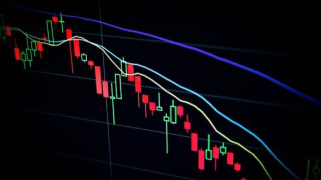 A candlestick stock chart showing a downward price trend on a dark trading screen.