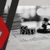 Poker chips and a judge’s gavel on top of a 1040 tax form with stacked casino chips nearby