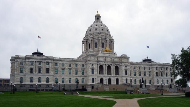 Minnesota State Capitol building in Saint Paul with large central dome and front lawn