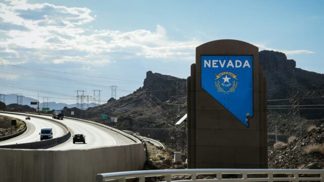 Nevada state welcome sign along a highway in a desert landscape