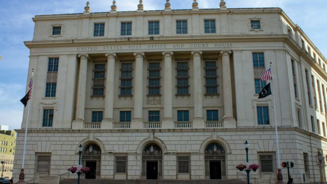 United States Post Office and Courthouse building with large columns and American flags outside