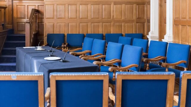 Empty courtroom with judge’s bench and seating prepared for a legal hearing on gambling regulation