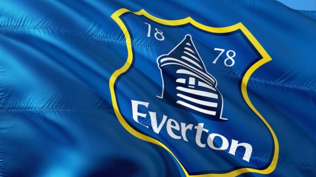 Everton club crest on a blue flag waving against the sky
