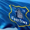 Everton club crest on a blue flag waving against the sky