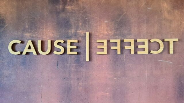 Wooden letters on textured brown bacgroun spell of Cause | Effect. Effect letters are in right ordewr, but mirrored. Words are separated by a matching wooden diivider