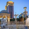 Exterior view of Caesars Palace hotel and casino in Las Vegas with fountains and Roman-style statues at dusk