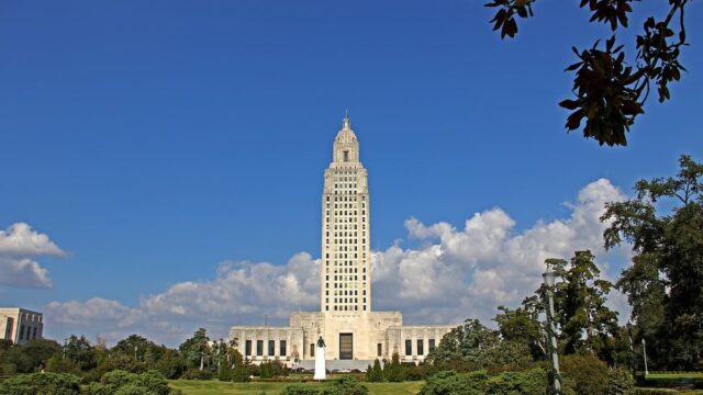 The Louisiana State Capitol building in Baton Rouge under a blue sky