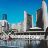 Toronto sign and Toronto City Hall buildings in downtown Toronto, Ontario, Canada.