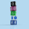 Stacked cubes displaying Facebook, Messenger, WhatsApp, Instagram and Threads logos against a blue background.