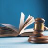 Judge's gavel beside an open law book representing gambling litigation, prediction market lawsuits and regulatory developments.