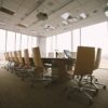 Empty corporate boardroom with a conference table and office chairs