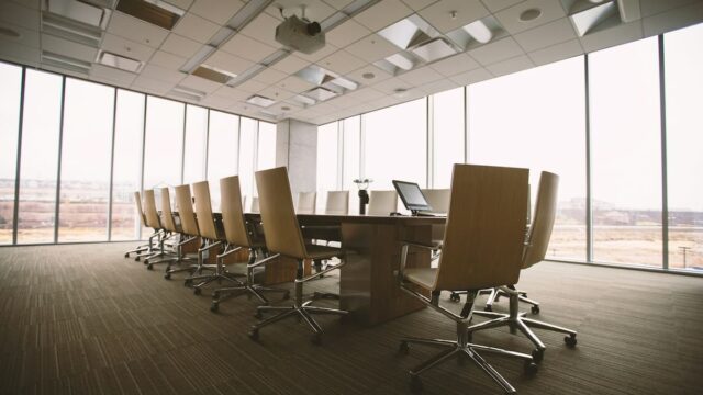 Empty corporate boardroom with a conference table and office chairs