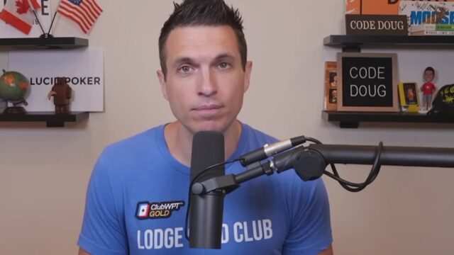 Doug Polk speaking into a microphone in a recording studio with poker memorabilia displayed on shelves behind him.