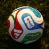 Official FIFA World Cup 2026 match ball resting on a grass pitch.