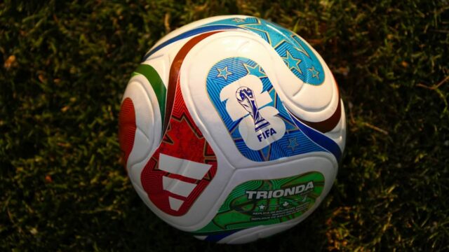 Official FIFA World Cup 2026 match ball resting on a grass pitch.