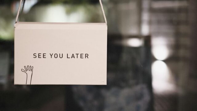 Hanging "See You Later" sign in a shop window