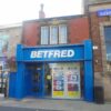 Exterior of a Betfred betting shop on a UK high street.