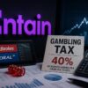 Entain logo alongside a gambling tax sign, betting imagery, a calculator and financial charts.