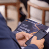 Attendee holds the SOFTSWISS 2027 iGaming Trends Report during its exclusive media launch ahead of SBC Summit.