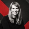 A photo of Lindsay Slader in front of a black and red background.