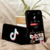 Two smartphones with the TikTok app and logo
