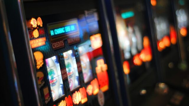Blurred close-up of illuminated slot machines in a row