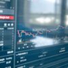Cryptocurrency trading platform displaying price charts, trading volume and open positions on a computer screen.